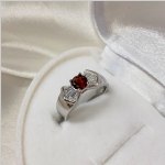 Gümüş yüzük “Güzelliğin Esareti”. Granat ve kübik zirkon