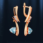 Earrings made of red gold with topaz. Bicolor