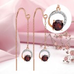 Gold pull-through earrings. Garnet and cubic zirconia