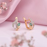 Gold earrings. Diamonds and emerald