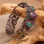 Silver bracelet with rubies and emerald
