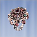 Silver ring with garnet and emeralds