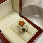 Silver ring with amber. Bicolor