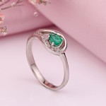 White gold ring with diamonds and emerald